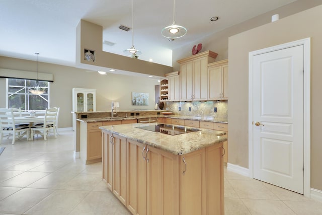 10120 Inverness Way, Port Saint Lucie, FL 34986 - kitchen featuring a sink, black electric cooktop, backsplash, a peninsula, and light tile patterned floors