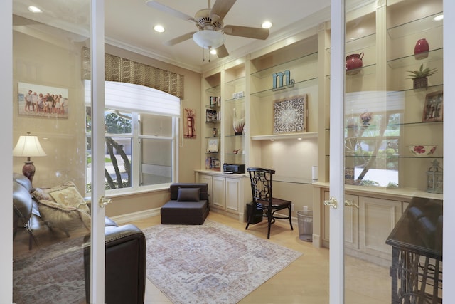 10120 Inverness Way, Port Saint Lucie, FL 34986 - home office with healthy amount of natural light, a ceiling fan, crown molding, light wood-type flooring, and built in desk