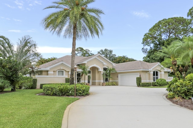 10120 Inverness Way, Port Saint Lucie, FL 34986 - single story home featuring concrete driveway, stucco siding, a front lawn, and a garage