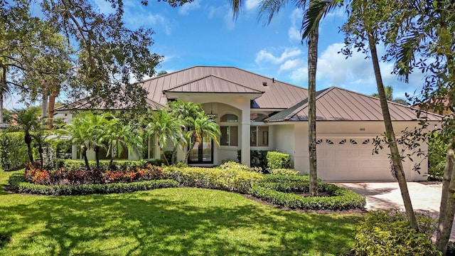 6845 Big Cypress Dr, Jupiter, FL 33458 - view of front of home with a standing seam roof, a metal roof, and a garage