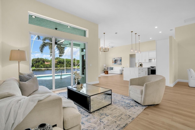 6845 Big Cypress Dr, Jupiter, FL 33458 - living room featuring light wood-style floors, a chandelier, and recessed lighting