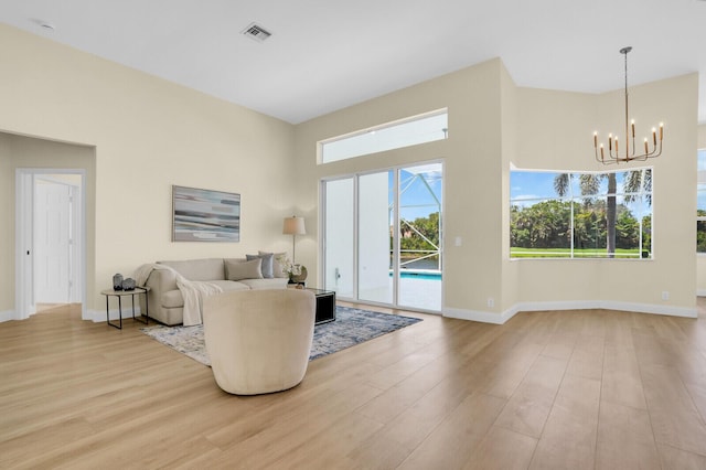 6845 Big Cypress Dr, Jupiter, FL 33458 - living room with a chandelier and light wood finished floors