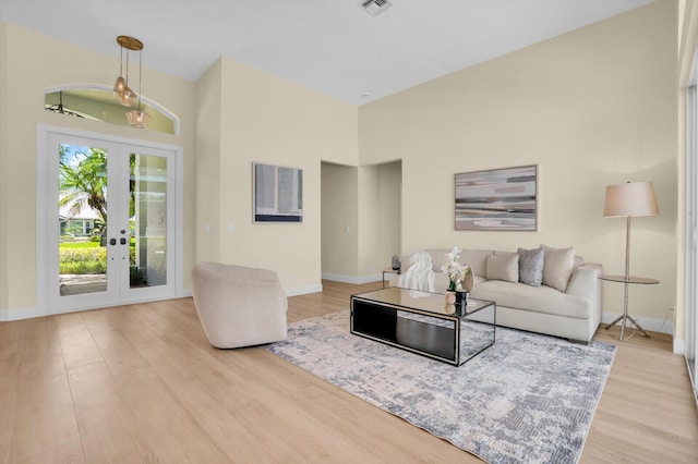 6845 Big Cypress Dr, Jupiter, FL 33458 - living room with french doors, wood finished floors, and a high ceiling