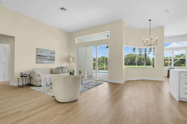 6845 Big Cypress Dr, Jupiter, FL 33458 - living area featuring a chandelier and light wood finished floors