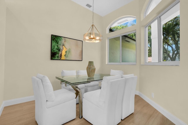 6845 Big Cypress Dr, Jupiter, FL 33458 - dining area with a chandelier and wood finished floors