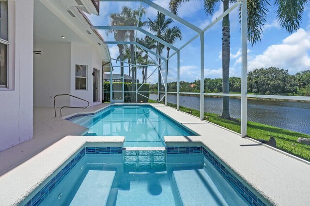 6845 Big Cypress Dr, Jupiter, FL 33458 - view of pool featuring a water view, a pool with connected hot tub, a patio area, and a lanai