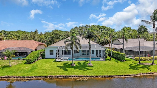 6845 Big Cypress Dr, Jupiter, FL 33458 - back of house featuring a lawn, glass enclosure, an outdoor pool, and a water view