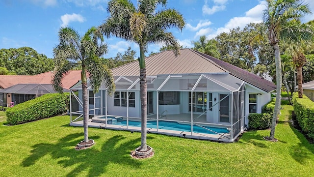 6845 Big Cypress Dr, Jupiter, FL 33458 - rear view of house featuring a lawn, a lanai, and a pool with connected hot tub