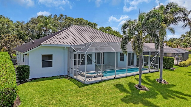 6845 Big Cypress Dr, Jupiter, FL 33458 - back of house with stucco siding, a yard, a standing seam roof, a metal roof, and a pool with connected hot tub