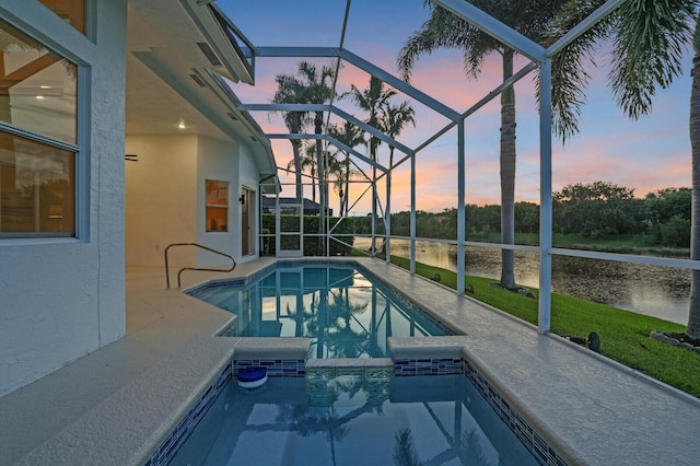 6845 Big Cypress Dr, Jupiter, FL 33458 - pool at dusk with a water view, an outdoor pool, a patio area, and glass enclosure