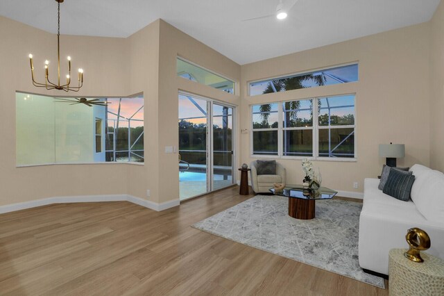 6845 Big Cypress Dr, Jupiter, FL 33458 - pool at dusk with a water view, a patio, ceiling fan, a pool with connected hot tub, and a lanai