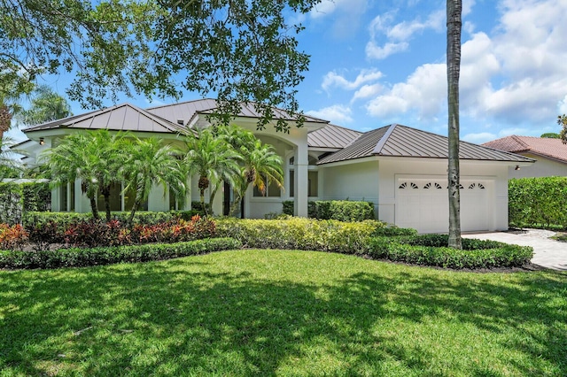 6845 Big Cypress Dr, Jupiter, FL 33458 - ranch-style house with a standing seam roof, a metal roof, a front yard, and an attached garage