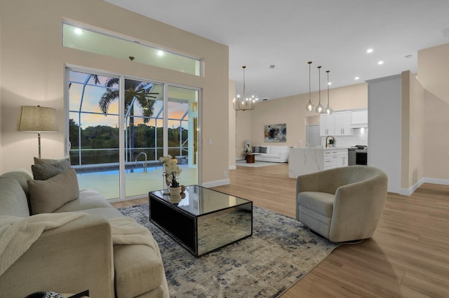 6845 Big Cypress Dr, Jupiter, FL 33458 - living area featuring light wood finished floors, a chandelier, and recessed lighting
