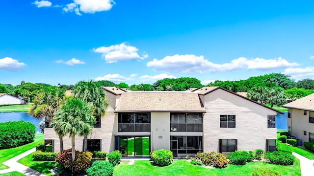 8641 Boca Glades D Blvd W Unit D, Boca Raton, FL 33434 - view of front facade with stucco siding, a front lawn, and a water view