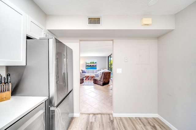 8641 Boca Glades D Blvd W Unit D, Boca Raton, FL 33434 - kitchen featuring white cabinets, light countertops, and light wood-type flooring