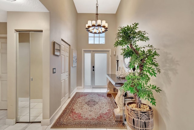 7574 Ironbridge Cir, Delray Beach, FL 33446 - foyer entrance featuring light tile patterned floors, a chandelier, and baseboards