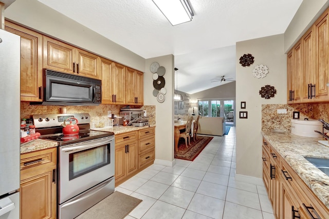 7574 Ironbridge Cir, Delray Beach, FL 33446 - kitchen with black microwave, electric stove, vaulted ceiling, backsplash, and light tile patterned floors