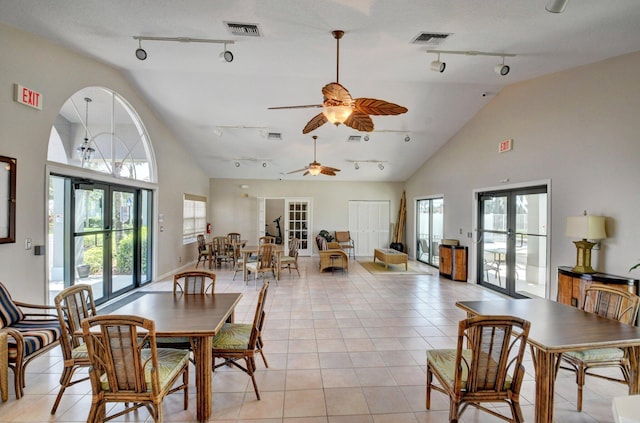7574 Ironbridge Cir, Delray Beach, FL 33446 - dining space with track lighting, ceiling fan, french doors, light tile patterned floors, and high vaulted ceiling