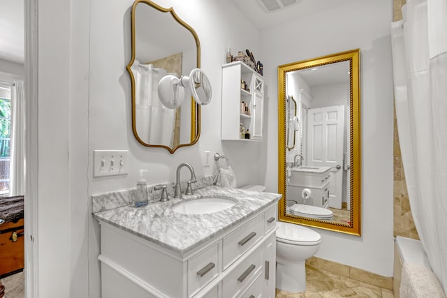 134 Worth Ct N, West Palm Beach, FL 33405 - bathroom with vanity, toilet, shower / bath combo, and baseboards