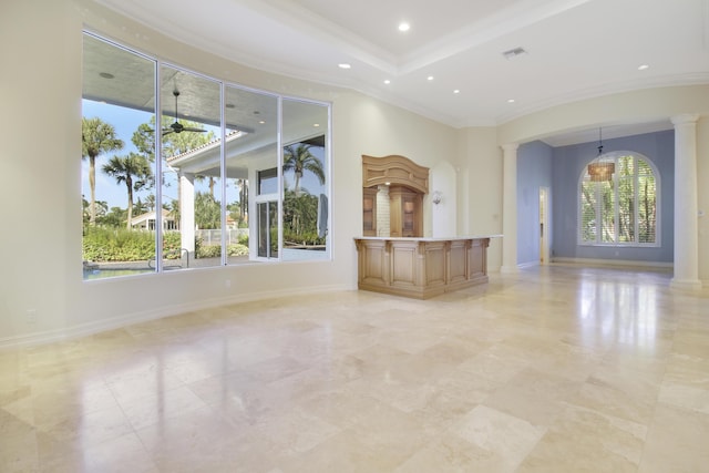 1186 Breakers W Blvd, West Palm Beach, FL 33411 - unfurnished living room featuring ornate columns, ornamental molding, a towering ceiling, recessed lighting, and baseboards