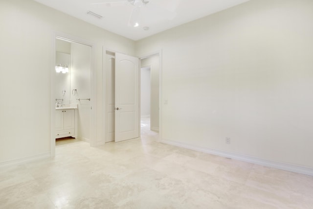 1186 Breakers W Blvd, West Palm Beach, FL 33411 - unfurnished bedroom with ensuite bathroom, ceiling fan, and baseboards