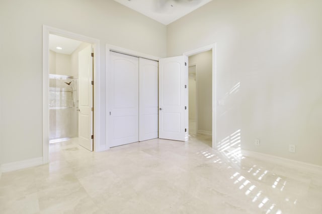 1186 Breakers W Blvd, West Palm Beach, FL 33411 - unfurnished bedroom with a closet, connected bathroom, and baseboards