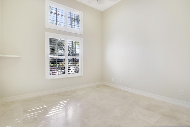 1186 Breakers W Blvd, West Palm Beach, FL 33411 - spare room with baseboards and a towering ceiling