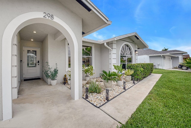 298 Las Palmas St, Royal Palm Beach, FL 33411 - property entrance featuring stucco siding and a lawn