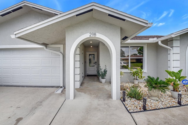 298 Las Palmas St, Royal Palm Beach, FL 33411 - entrance to property with stucco siding, driveway, and an attached garage