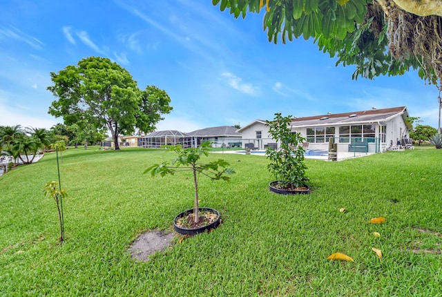 298 Las Palmas St, Royal Palm Beach, FL 33411 - view of green lawn with a patio area, a swimming pool, and a lanai