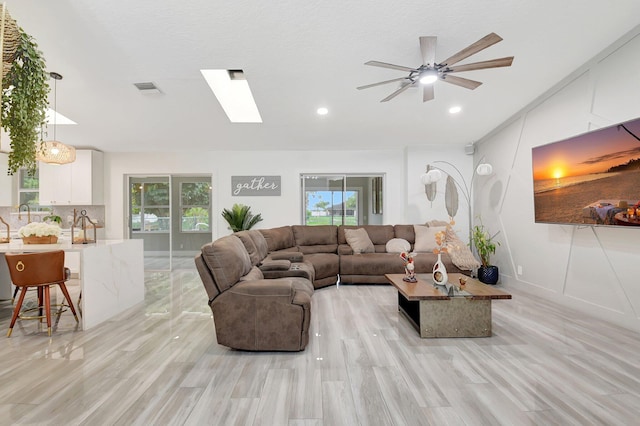 298 Las Palmas St, Royal Palm Beach, FL 33411 - living area with a skylight, healthy amount of natural light, ceiling fan, recessed lighting, and light wood-style floors