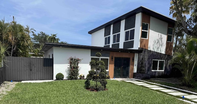3056 NE 14th Ave, Oakland Park, FL 33334 - contemporary home featuring stucco siding and french doors