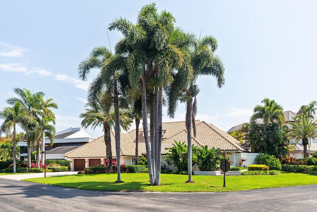 4700 Sanctuary Ln, Boca Raton, FL 33431 - view of front of home featuring a tiled roof, a front yard, a garage, driveway, and stucco siding