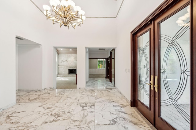 4700 Sanctuary Ln, Boca Raton, FL 33431 - foyer entrance featuring french doors, a chandelier, marble finish flooring, a fireplace, and a towering ceiling