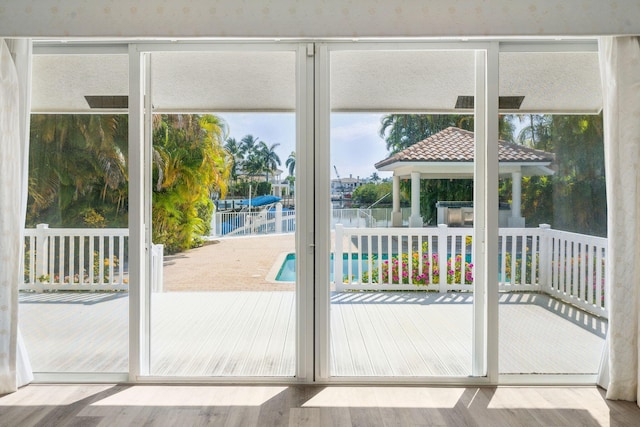 4700 Sanctuary Ln, Boca Raton, FL 33431 - doorway with wood finished floors and a water view