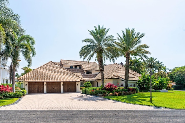 4700 Sanctuary Ln, Boca Raton, FL 33431 - mediterranean / spanish home with stucco siding, a tiled roof, an attached garage, a front yard, and driveway