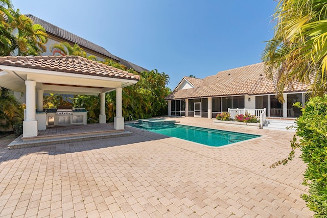 4700 Sanctuary Ln, Boca Raton, FL 33431 - view of swimming pool featuring a gazebo, a sunroom, an outdoor kitchen, a patio, and a pool with connected hot tub