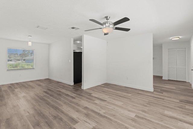 798 SE Atlantus Ave, Port Saint Lucie, FL 34983 - unfurnished room featuring light wood-style floors, a ceiling fan, and baseboards