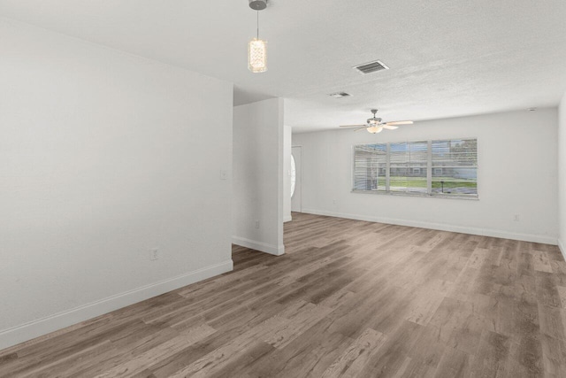 798 SE Atlantus Ave, Port Saint Lucie, FL 34983 - unfurnished room with baseboards, wood finished floors, and ceiling fan