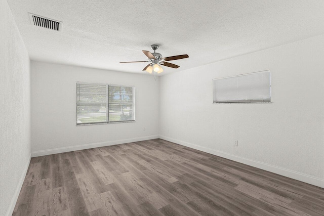 798 SE Atlantus Ave, Port Saint Lucie, FL 34983 - empty room featuring wood finished floors, ceiling fan, a textured ceiling, and baseboards