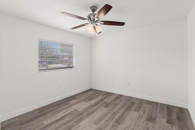 798 SE Atlantus Ave, Port Saint Lucie, FL 34983 - unfurnished room featuring wood finished floors, baseboards, ceiling fan, and a textured ceiling