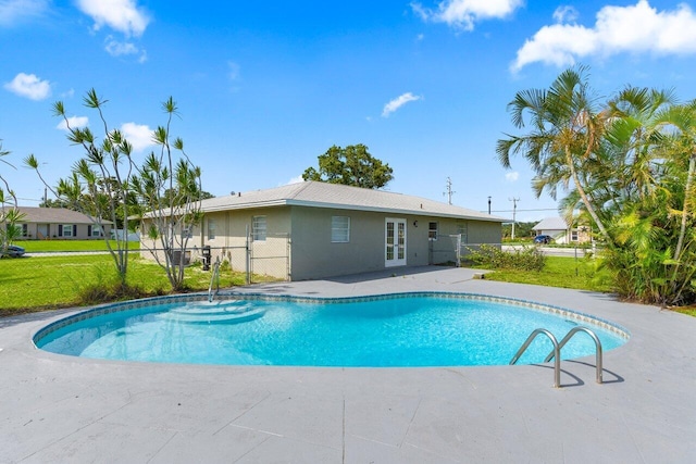 798 SE Atlantus Ave, Port Saint Lucie, FL 34983 - outdoor pool featuring french doors and a patio