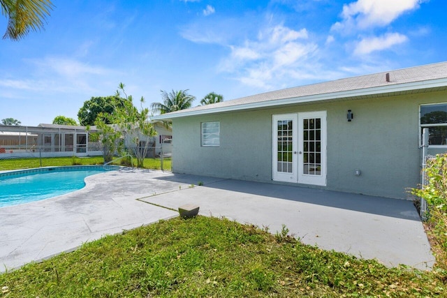 798 SE Atlantus Ave, Port Saint Lucie, FL 34983 - view of pool with french doors, a patio area, and a lawn