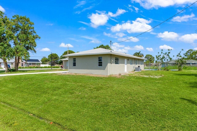 798 SE Atlantus Ave, Port Saint Lucie, FL 34983 - view of side of property with stucco siding and central air condition unit