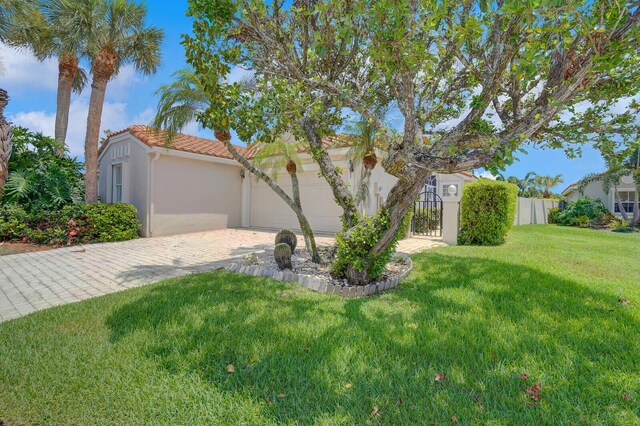 7158 Foxworth Ct, Boynton Beach, FL 33437 - mediterranean / spanish house featuring stucco siding, a tile roof, an attached garage, and driveway