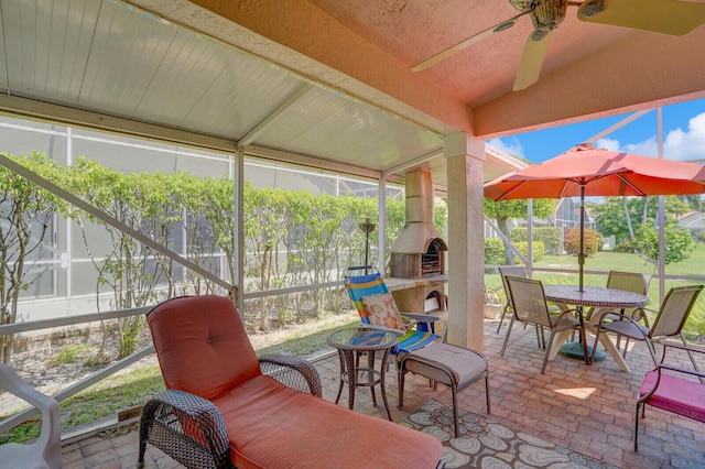 7158 Foxworth Ct, Boynton Beach, FL 33437 - sunroom with an outdoor fireplace, a ceiling fan, outdoor dining area, and vaulted ceiling