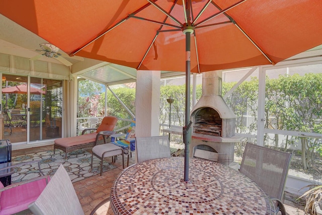 7158 Foxworth Ct, Boynton Beach, FL 33437 - sunroom with an outdoor fireplace, outdoor dining area, ceiling fan, and plenty of natural light