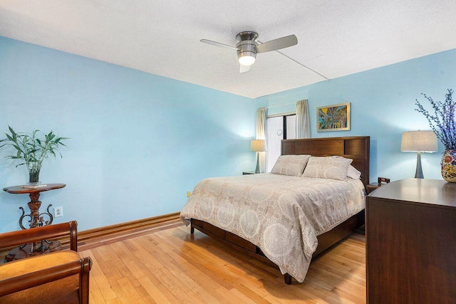 5200 E Club Cir Unit 106, Boca Raton, FL 33487 - bedroom featuring light wood-type flooring, ceiling fan, baseboards, and a textured ceiling