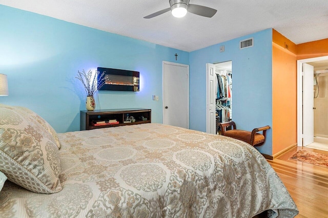 5200 E Club Cir Unit 106, Boca Raton, FL 33487 - bedroom with wood finished floors, a closet, ceiling fan, baseboards, and a walk in closet