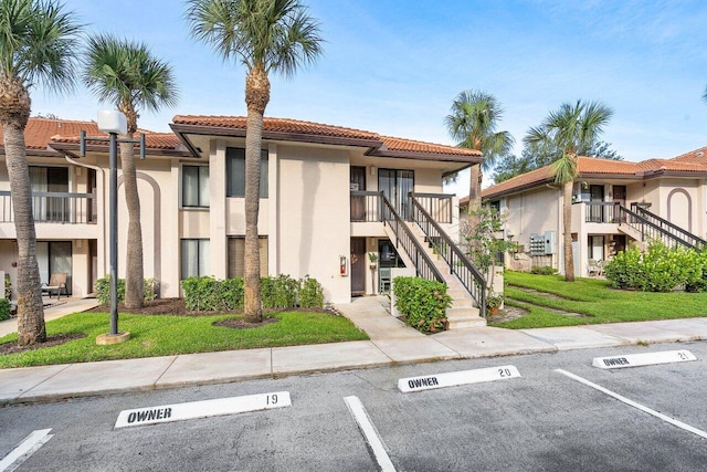 5200 E Club Cir Unit 106, Boca Raton, FL 33487 - view of building exterior featuring uncovered parking and stairway